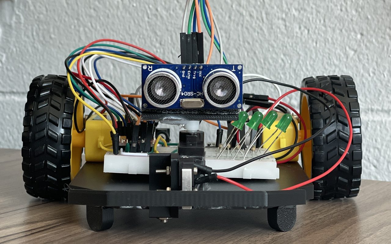 Autonomous mobile robot with an ultrasonic sensor and LED array on a 3D-printed chassis
